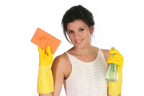Cleaner working in a Streatham family home with attention to living room surfaces